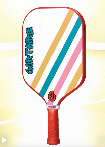 Colorful striped pickleball paddle on a yellow background